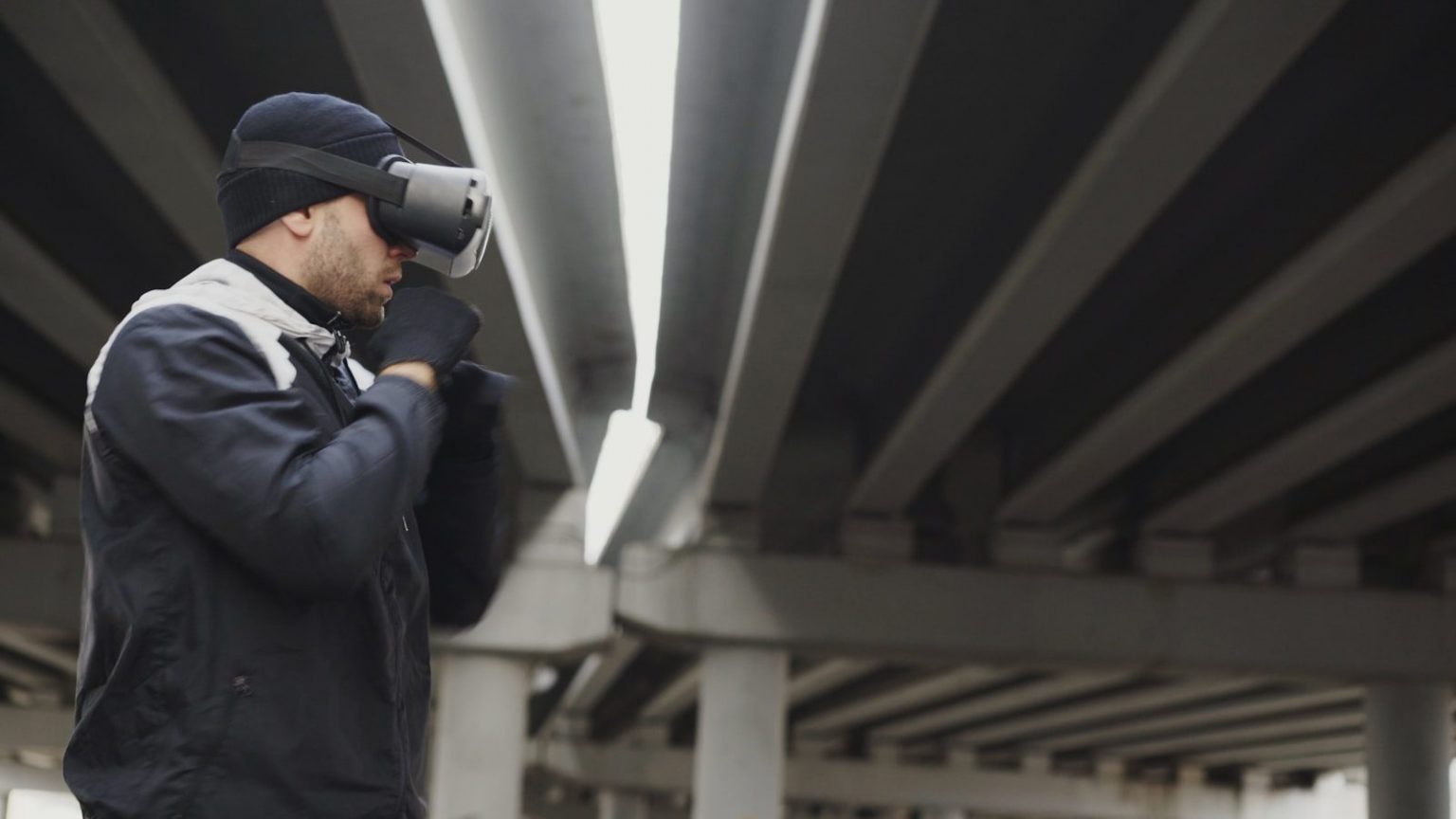 Man wearing vr headset under concrete bridge