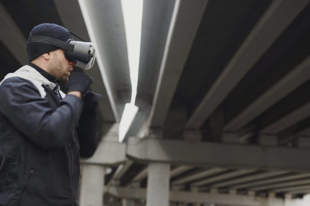 Man wearing vr headset under concrete bridge