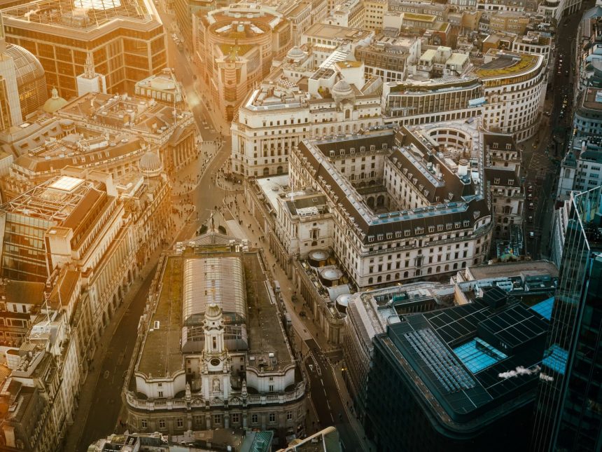 Stunning aerial view of London's financial district with golden hour lighting.