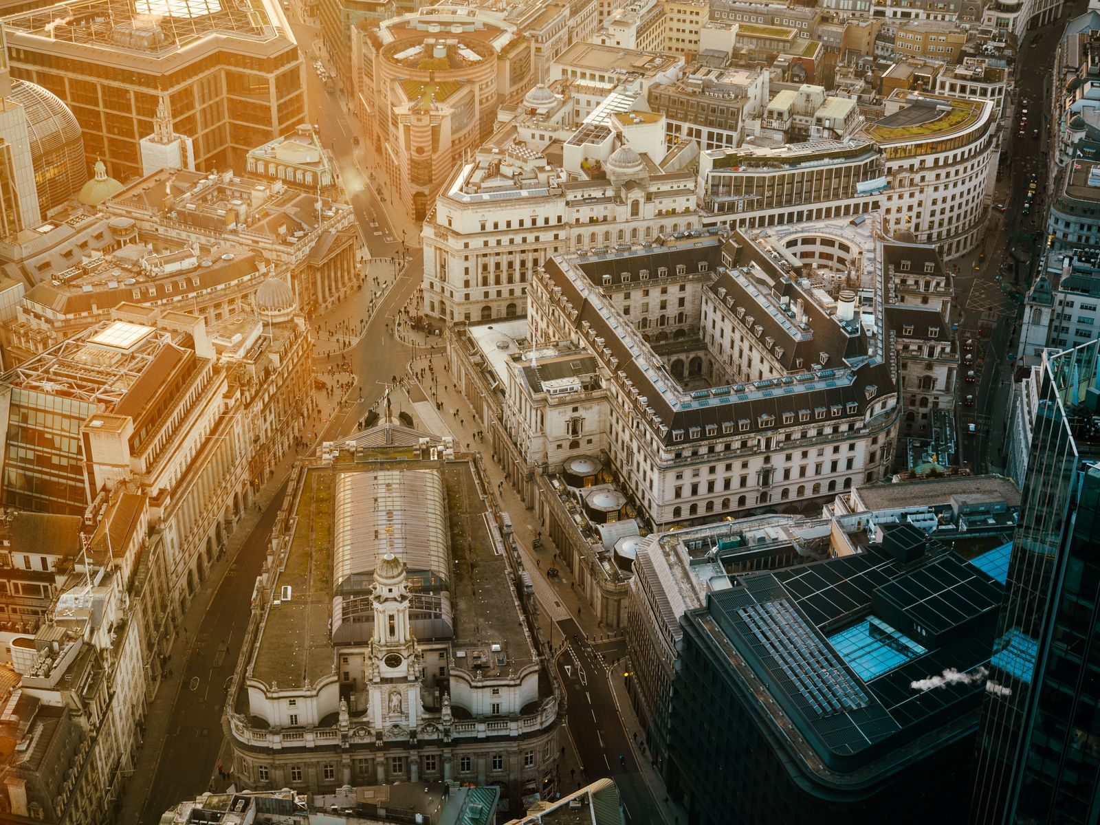 Stunning aerial view of London's financial district with golden hour lighting.