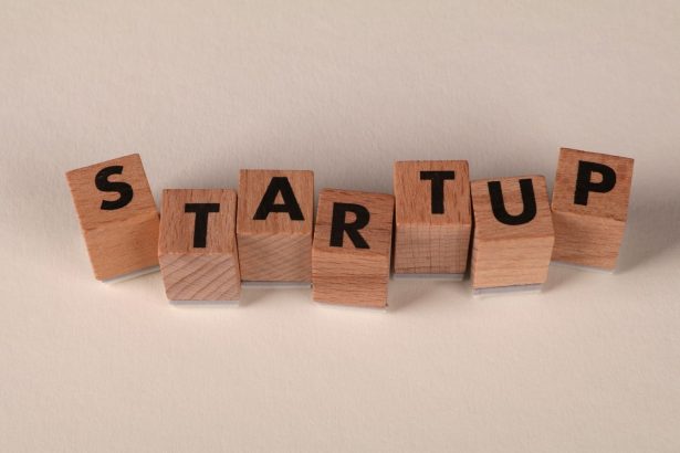 Wooden blocks forming the word 'STARTUP' on a neutral background, symbolizing new business ventures.
